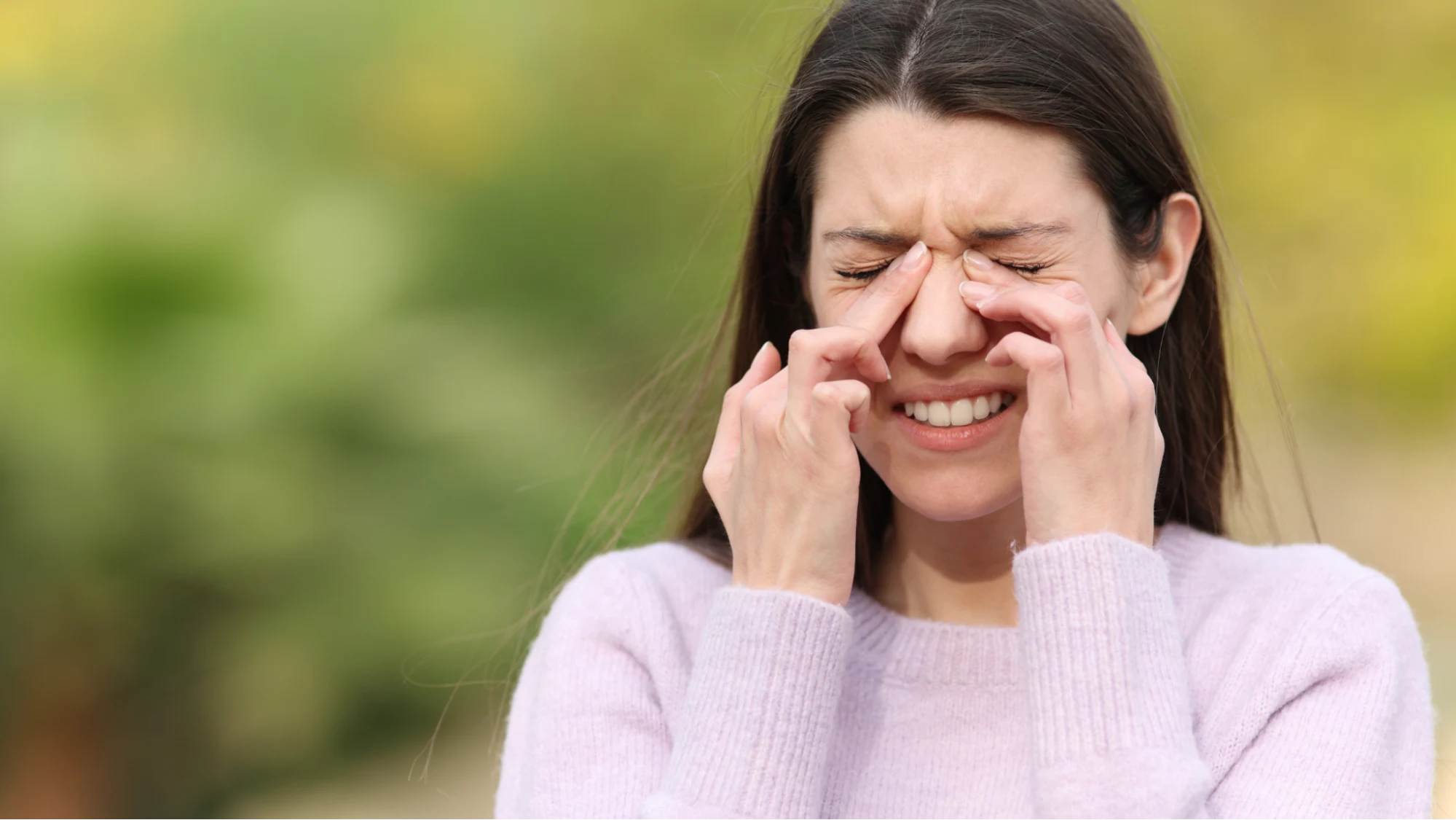 Woman rubbing dry, itchy eyes showing discomfort from chronic dry eye condition